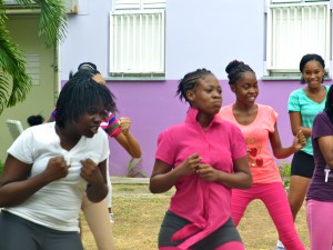 Young women at the I'm Glad I'm a Girl Foundation's summer camp at Mary Seacole Hall last week warming up for a self-defense session with martial arts experts.