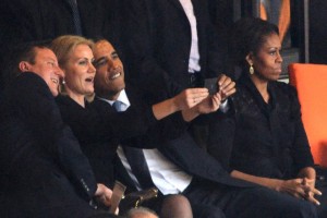 US President  Barack Obama (R) and British Prime Minister David Cameron pose for a picture with Denmark's Prime Minister Helle Thorning Schmidt (C) next to US First Lady Michelle Obama (R) during the memorial service of South African former president Nelson Mandela at the FNB Stadium (Soccer City) in Johannesburg on December 10, 2013.   AFP PHOTO / ROBERTO SCHMIDTROBERTO SCHMIDT/AFP/Getty Images