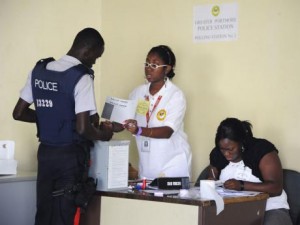 A policeman getting advice on how to fold his ballot paper from an EOJ official during the 2011 general election. (Photo: Gleaner)