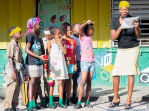 Teacher at Tarrant Primary School, Melissa Brown, leads students in a skit commemorating Universal Adult Suffrage. (Photo: Gleaner)