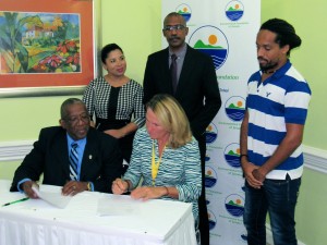 The White River Marine Association's grant, being signed here with Professor Dale Webber, Chair of the EFJ, is in support of coral reef restoration - part of a five-year plan with the support of local fishermen, nearby hotels and the Oracabessa Foundation. (My photo) 